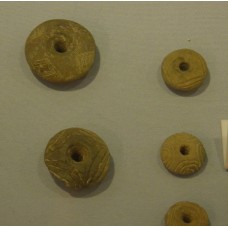 Solar cross on spindle whorls, loom weights